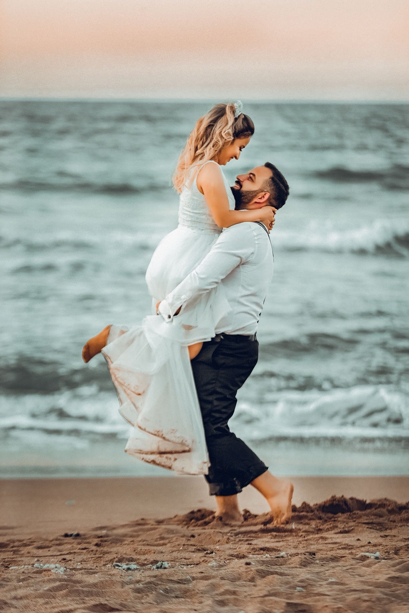 Bride and groom walking on a beach